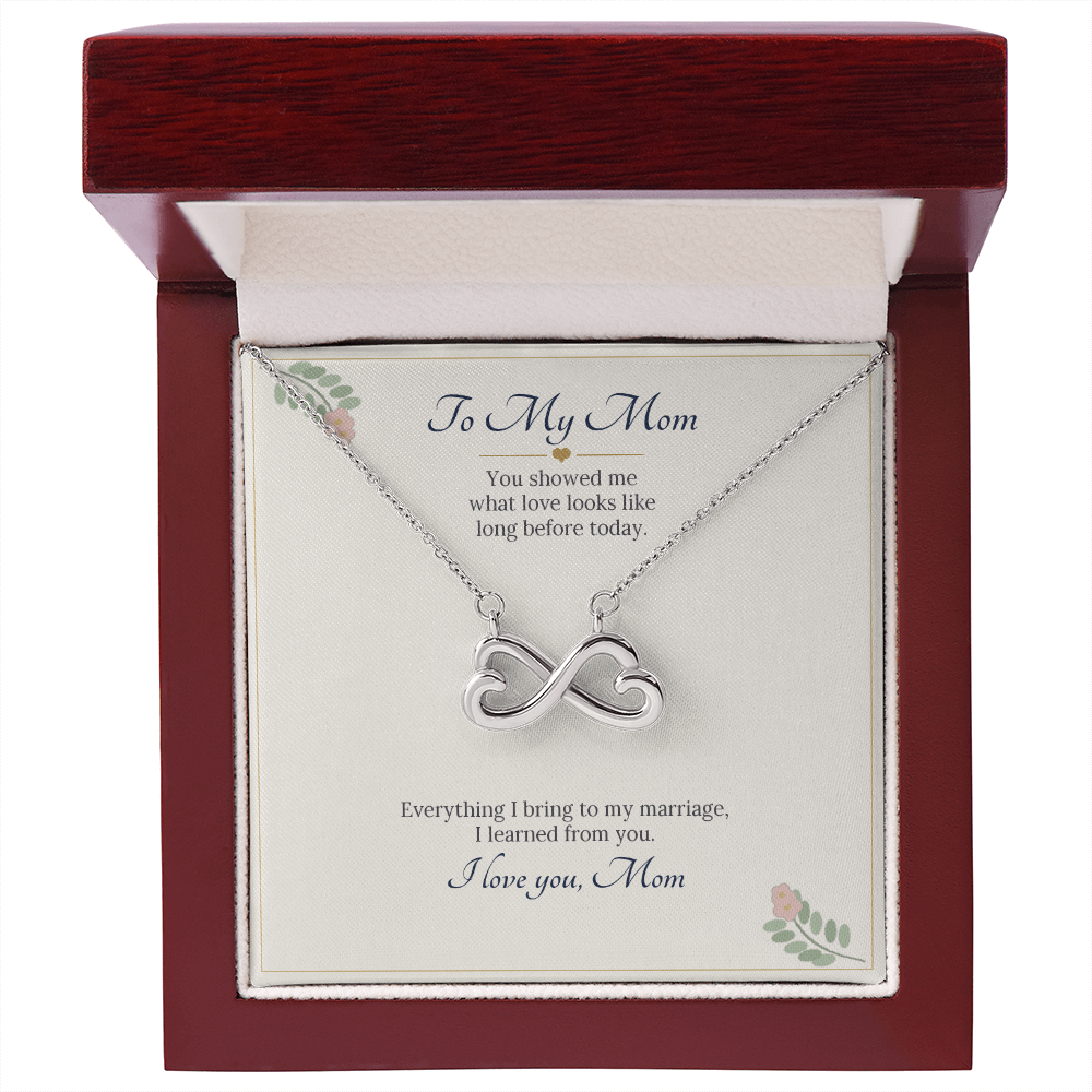 White gold finish infinity heart necklace on the To My Mom wedding card inside a wooden luxury box