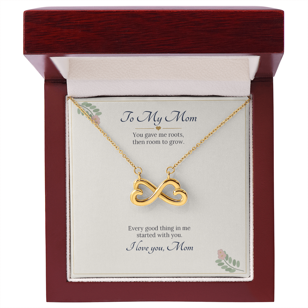 Yellow gold finish infinity heart necklace on the To My Mom card inside an open wooden luxury box