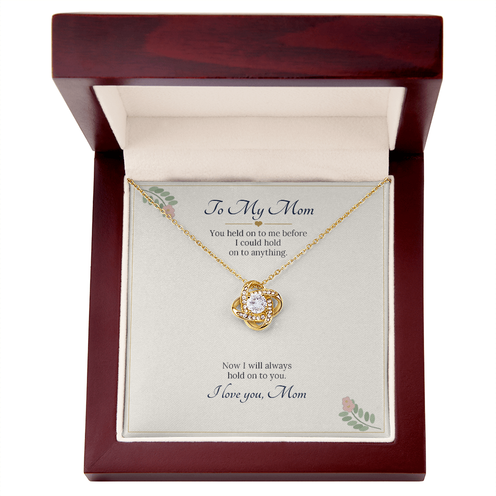 Yellow gold finish love knot necklace on the To My Mom card inside a wooden luxury box