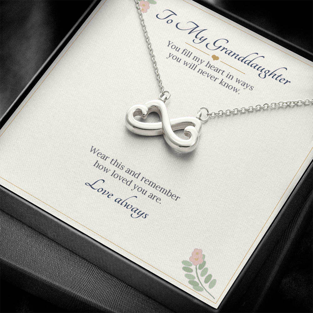 White gold finish infinity heart necklace on the To My Granddaughter card inside a black gift box