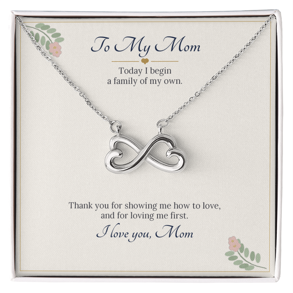 Infinity heart necklace in white gold finish on a cream To My Mom wedding message card, a gift for the mother of the groom