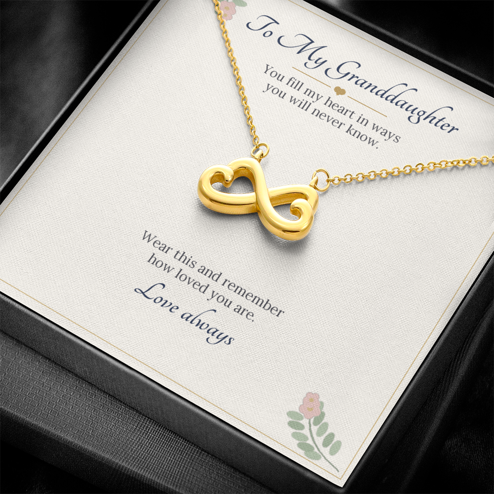 Yellow gold finish infinity heart necklace on the To My Granddaughter card inside a black gift box