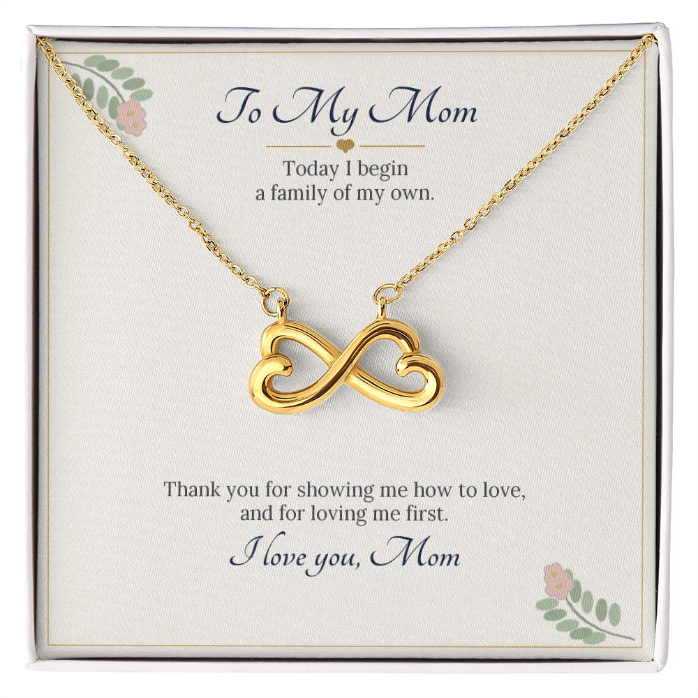 Infinity heart necklace in yellow gold finish on a cream To My Mom wedding message card