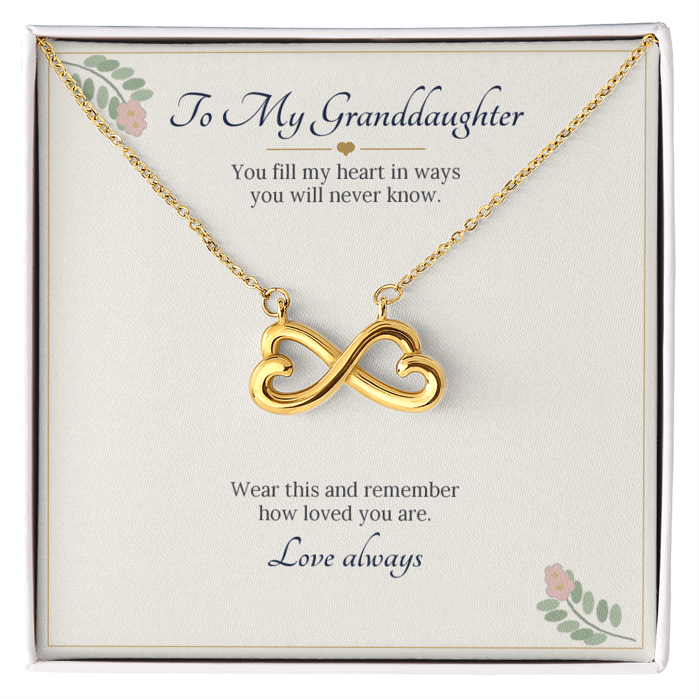 Infinity heart necklace in yellow gold finish on a cream To My Granddaughter message card