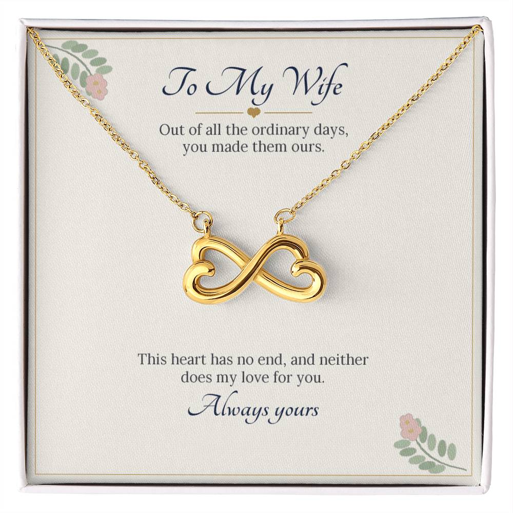 Infinity heart necklace in yellow gold finish on a cream To My Wife message card